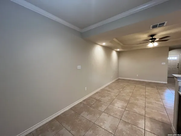 a view of a room with a ceiling fan and window