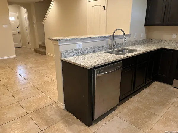 a kitchen with a sink vanity and a mirror