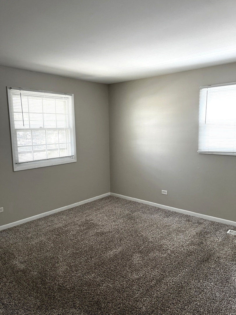 16524 Woodlawn W Avenue South Holland, IL 60473 - Photo 14 of 20 an empty room with windows