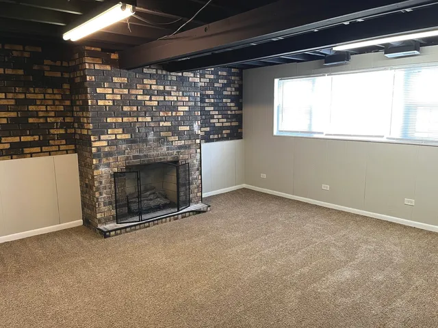 a view of an empty room with a fireplace