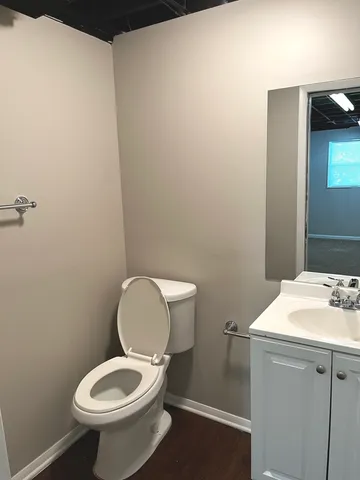 a white toilet sitting next to a bathroom sink