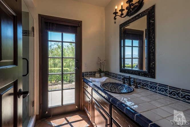 2016 Rayshire Street Thousand Oaks, CA 91362 - Photo 31 of 66 a bathroom with a granite countertop sink a mirror a vanity and a shower