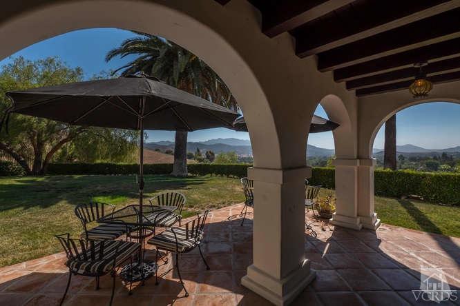 2016 Rayshire Street Thousand Oaks, CA 91362 - Photo 59 of 66 a view of a roof deck with table and chairs under an umbrella