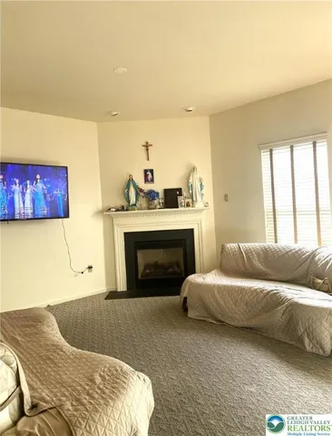 a living room with a couch and a fireplace