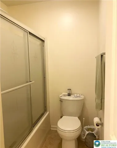 a bedroom with a bed and a chair