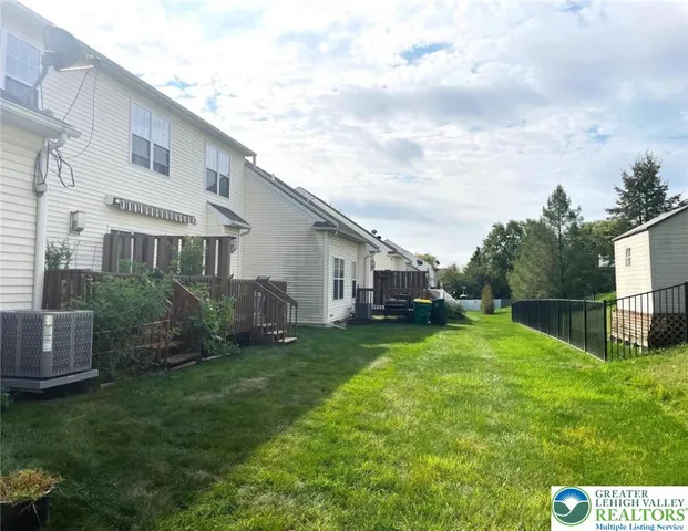 a view of a house with a yard and sitting area