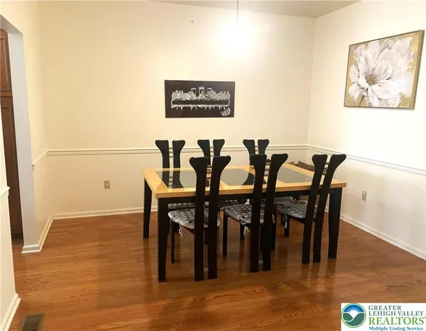 a view of a dining area with furniture and wooden floor