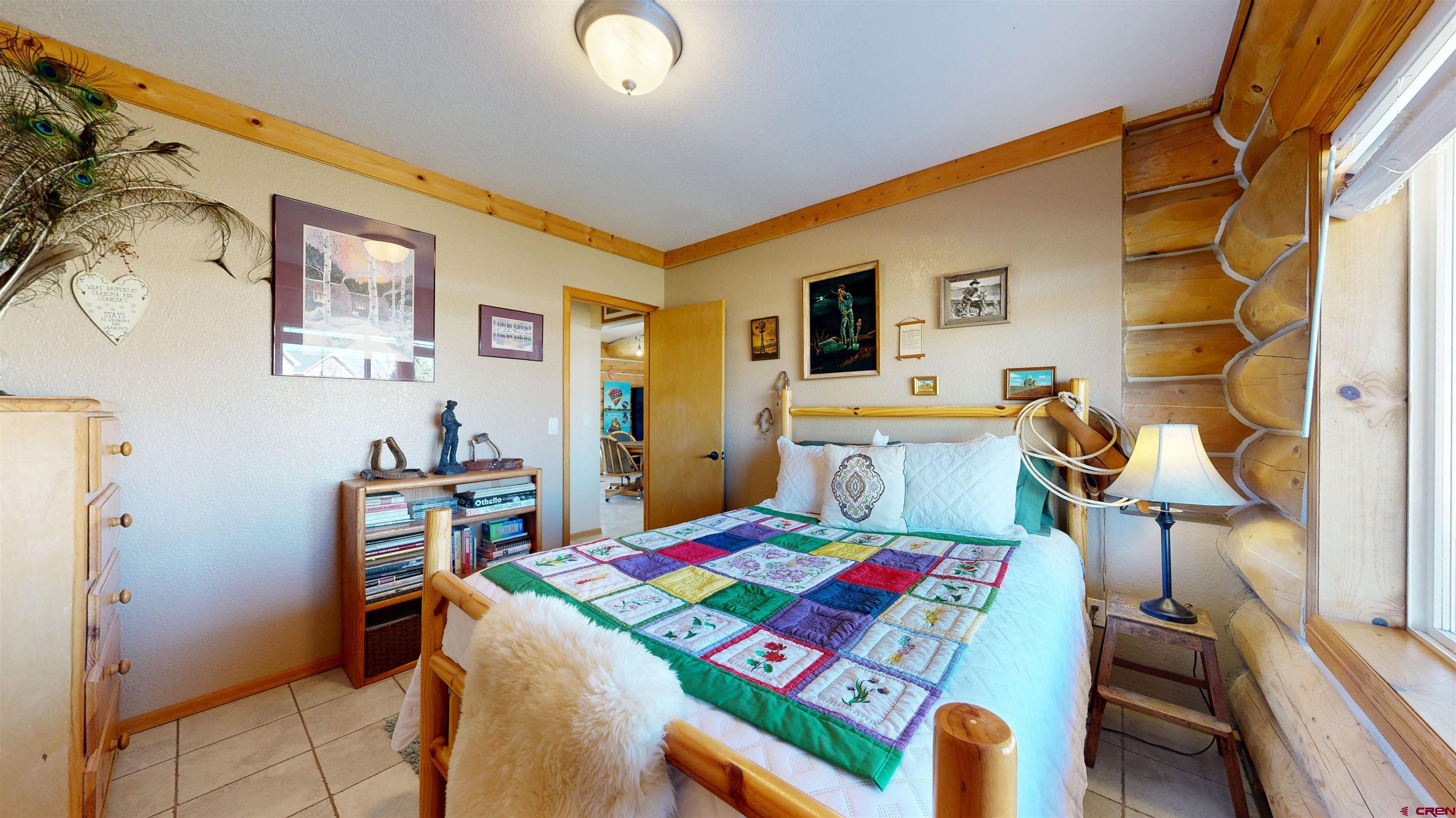 2083 Pioneer Road Delta, CO 81416 - Photo 17 of 45 a room that has a bed and a table in it