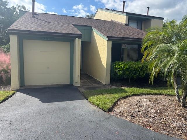 149 Club House Boulevard, Unit 149 New Smyrna Beach, FL 32168 - Photo 1 of 32 a front view of a house with garden