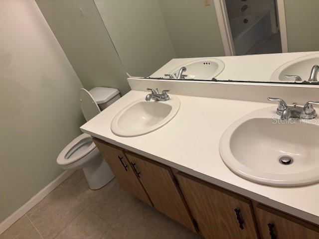 149 Club House Boulevard, Unit 149 New Smyrna Beach, FL 32168 - Photo 12 of 32 a bathroom with a sink and a toilet