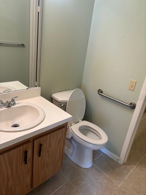 149 Club House Boulevard, Unit 149 New Smyrna Beach, FL 32168 - Photo 14 of 32 a bathroom with a sink a toilet and a mirror