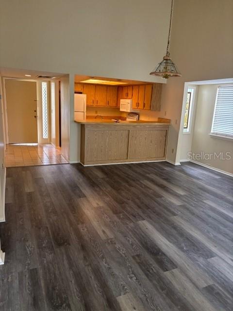 149 Club House Boulevard, Unit 149 New Smyrna Beach, FL 32168 - Photo 15 of 32 a view of a kitchen with wooden floor and windows