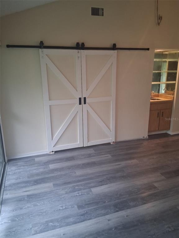 149 Club House Boulevard, Unit 149 New Smyrna Beach, FL 32168 - Photo 20 of 32 a view of an empty room with wooden floor