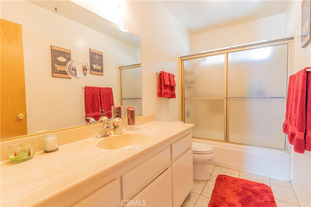 17516 Olive Street Hesperia, CA 92345 - Photo 19 of 32 a bathroom with a sink vanity mirror and toilet