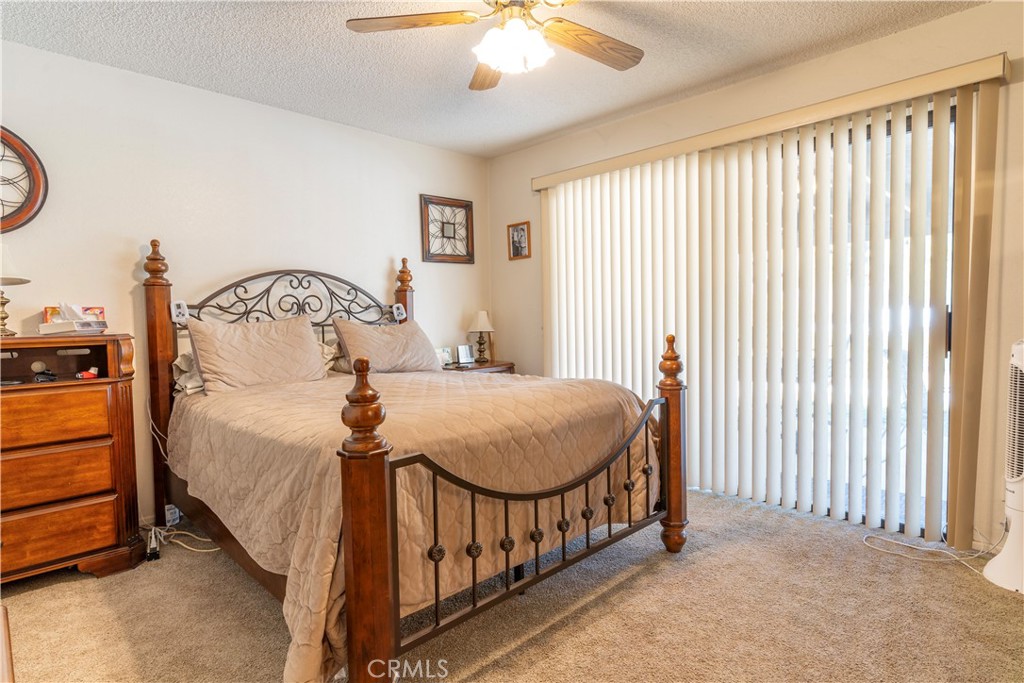 17516 Olive Street Hesperia, CA 92345 - Photo 20 of 32 a bedroom with a bed and a chandelier