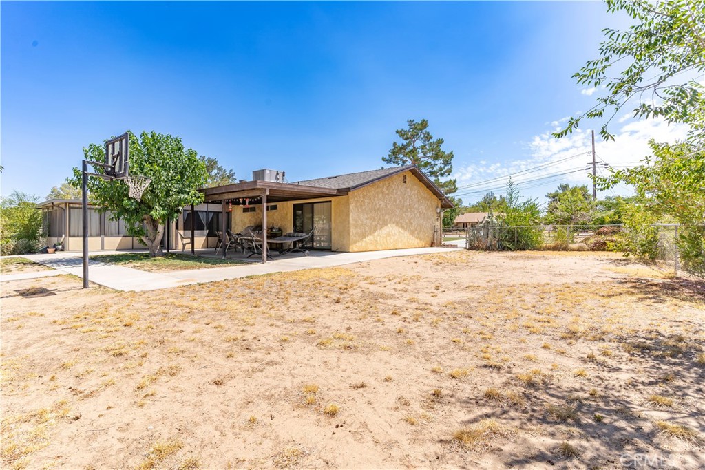 17516 Olive Street Hesperia, CA 92345 - Photo 24 of 32 a house with trees in front of it
