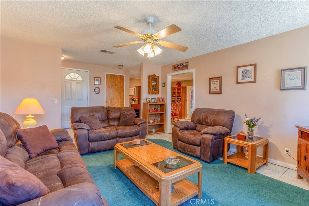 17516 Olive Street Hesperia, CA 92345 - Photo 5 of 32 a living room with furniture a table and a chandelier