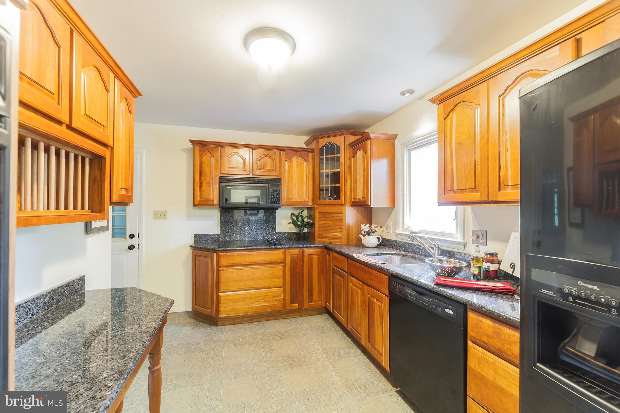 3804 Sweet Air Road Phoenix, MD 21131 - Photo 7 of 15 a kitchen with stainless steel appliances granite countertop sink stove and granite counter top