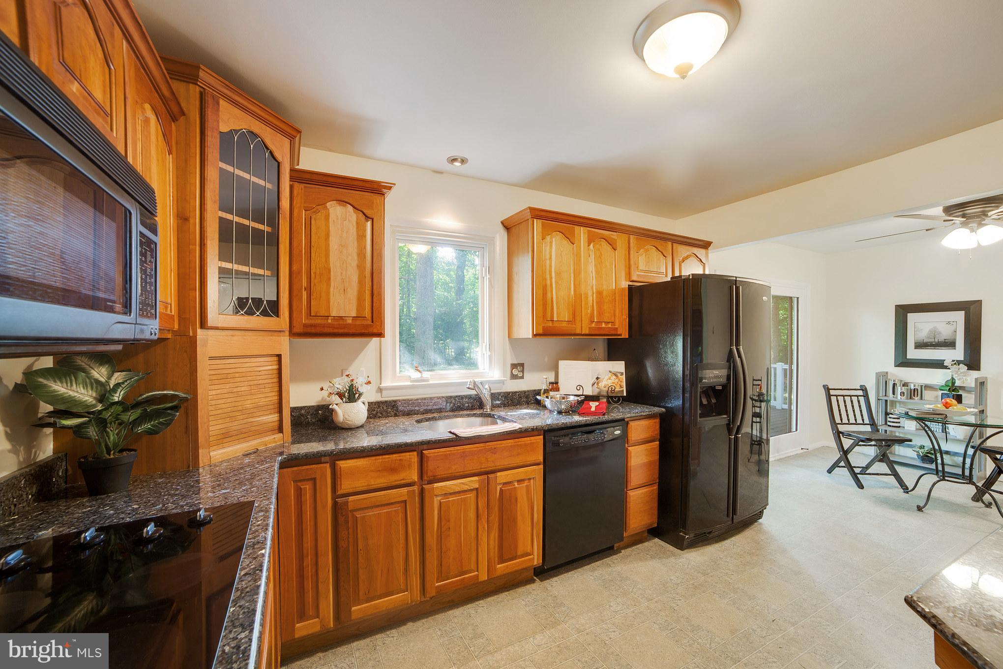 3804 Sweet Air Road Phoenix, MD 21131 - Photo 8 of 15 a kitchen with stainless steel appliances granite countertop a refrigerator and a stove top oven