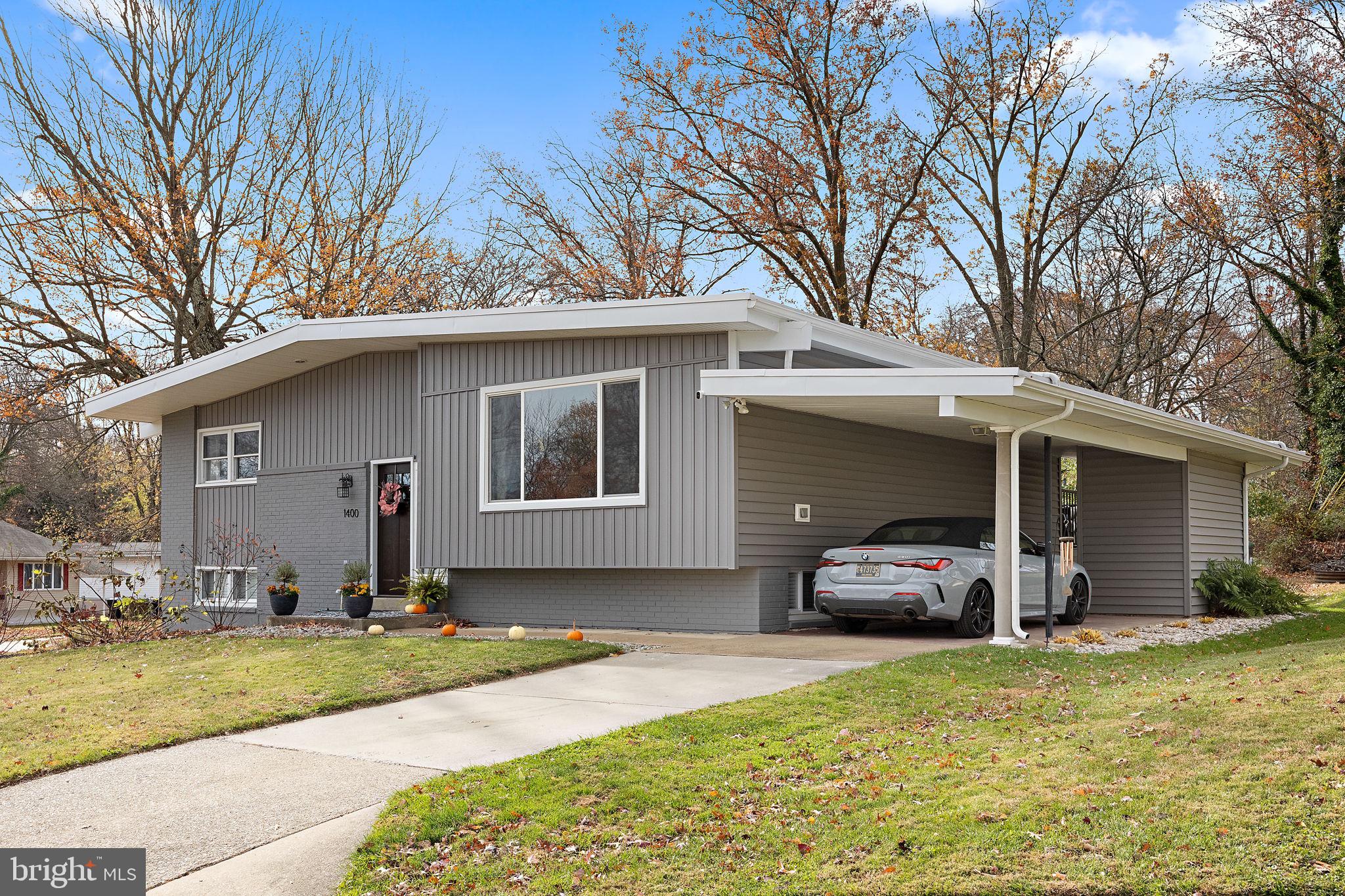 a front view of house with yard outdoor seating and barbeque oven