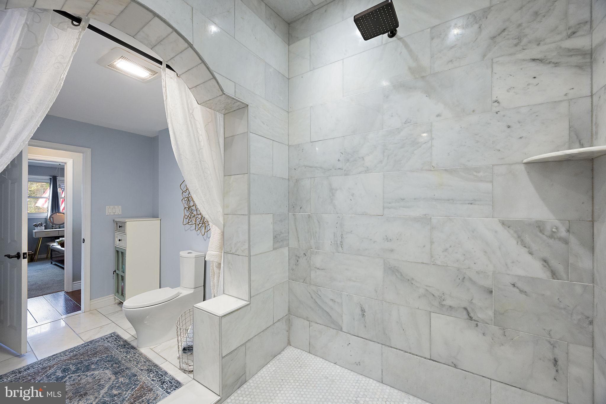 1400 Carson Road Wilmington, DE 19803 - Photo 19 of 44 a bathroom with a toilet and a shower