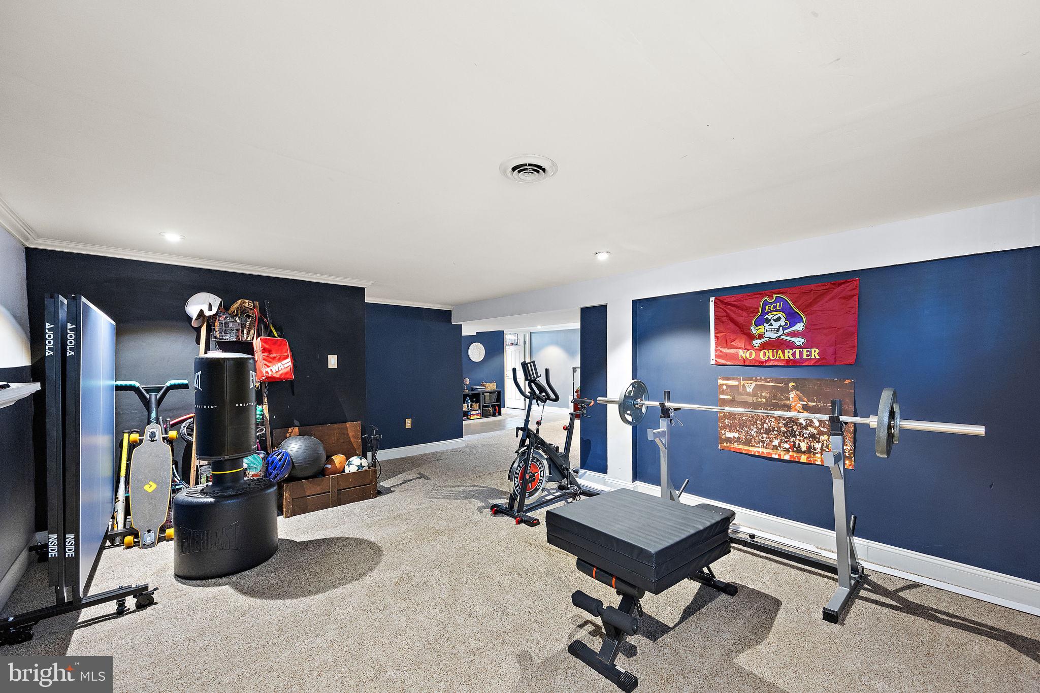 1400 Carson Road Wilmington, DE 19803 - Photo 35 of 44 a room with gym equipment and a flat screen tv