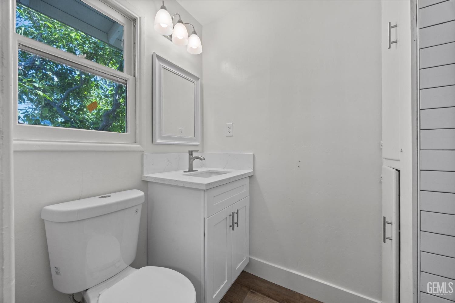 Undisclosed Address Bakersfield, CA 93301 - Photo 27 of 33 a bathroom with a toilet sink and mirror