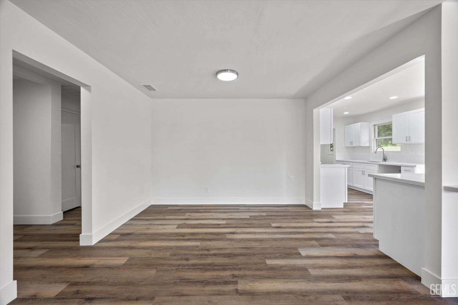 Undisclosed Address Bakersfield, CA 93301 - Photo 6 of 33 a view of kitchen and hall with wooden floor