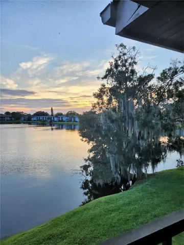 a view of a lake with houses in back