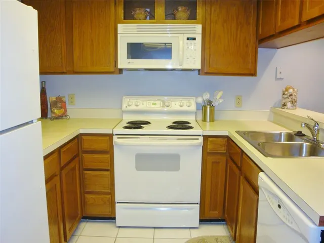 a kitchen with a stove cabinets and a refrigerator