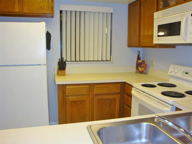 a kitchen with a refrigerator and a sink