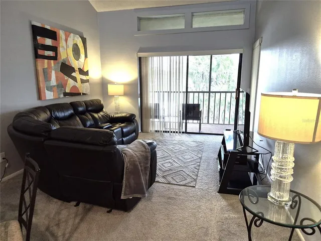 a living room with furniture and a lamp