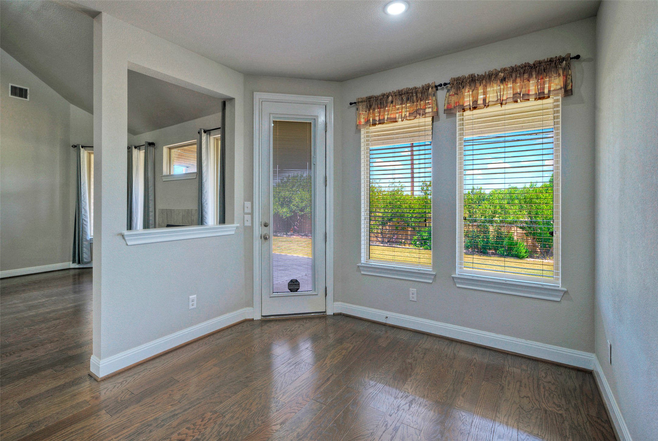 2260 Hat Bender Loop Round Rock, TX 78664 - Photo 16 of 40 Rich hardwood flooring extends through this breakfast nook, offering views of the private yard.