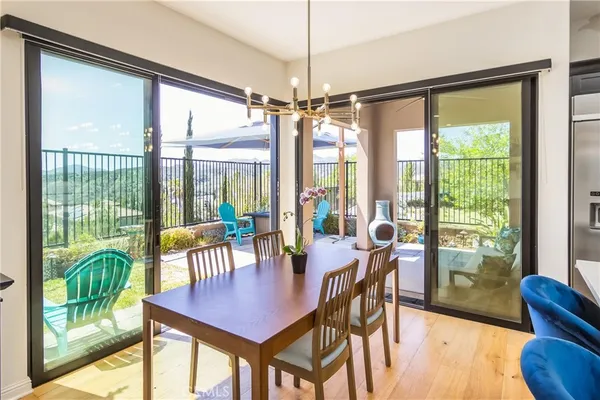 a dining room with furniture a chandelier and wooden floor