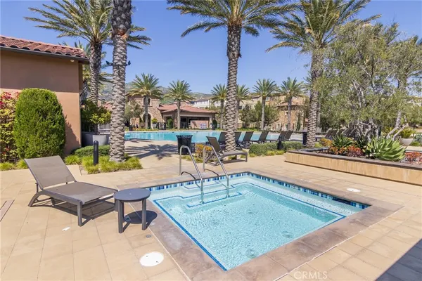 a swimming pool with outdoor seating and yard