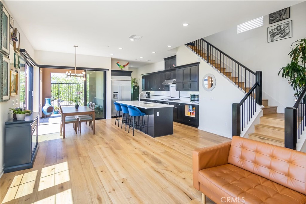 20724 Beech Circle Porter Ranch, CA 91326 - Photo 4 of 27 a living room with stainless steel appliances granite countertop furniture wooden floor and a kitchen view