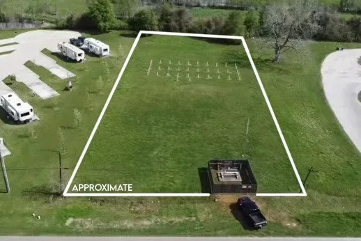 a view of a field of grass and trees