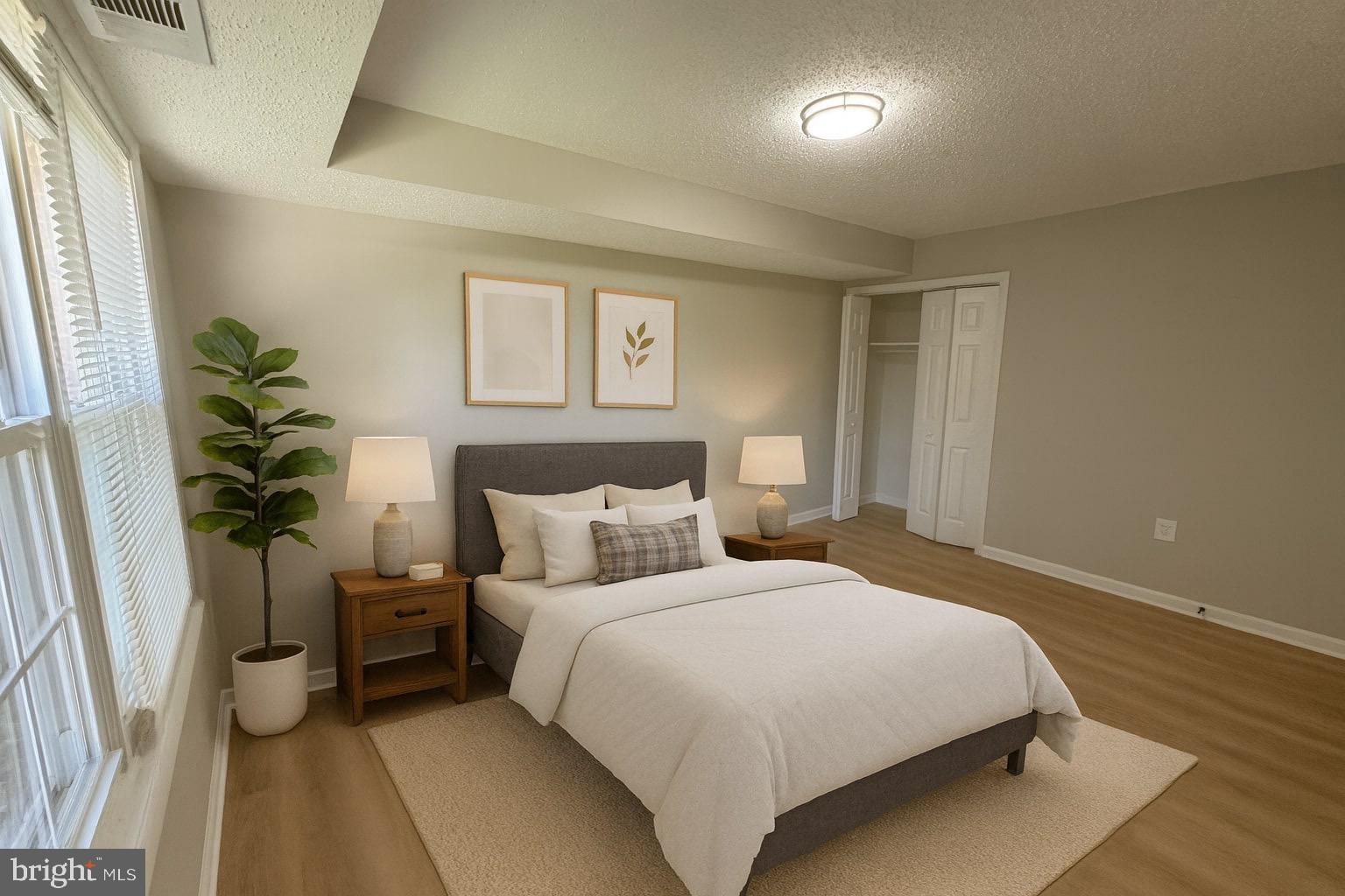 3817 Swann Road, Unit 302 Suitland, MD 20746 - Photo 11 of 26 a bedroom with a bed and a potted plant