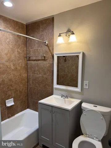 a bathroom with a sink mirror and toilet