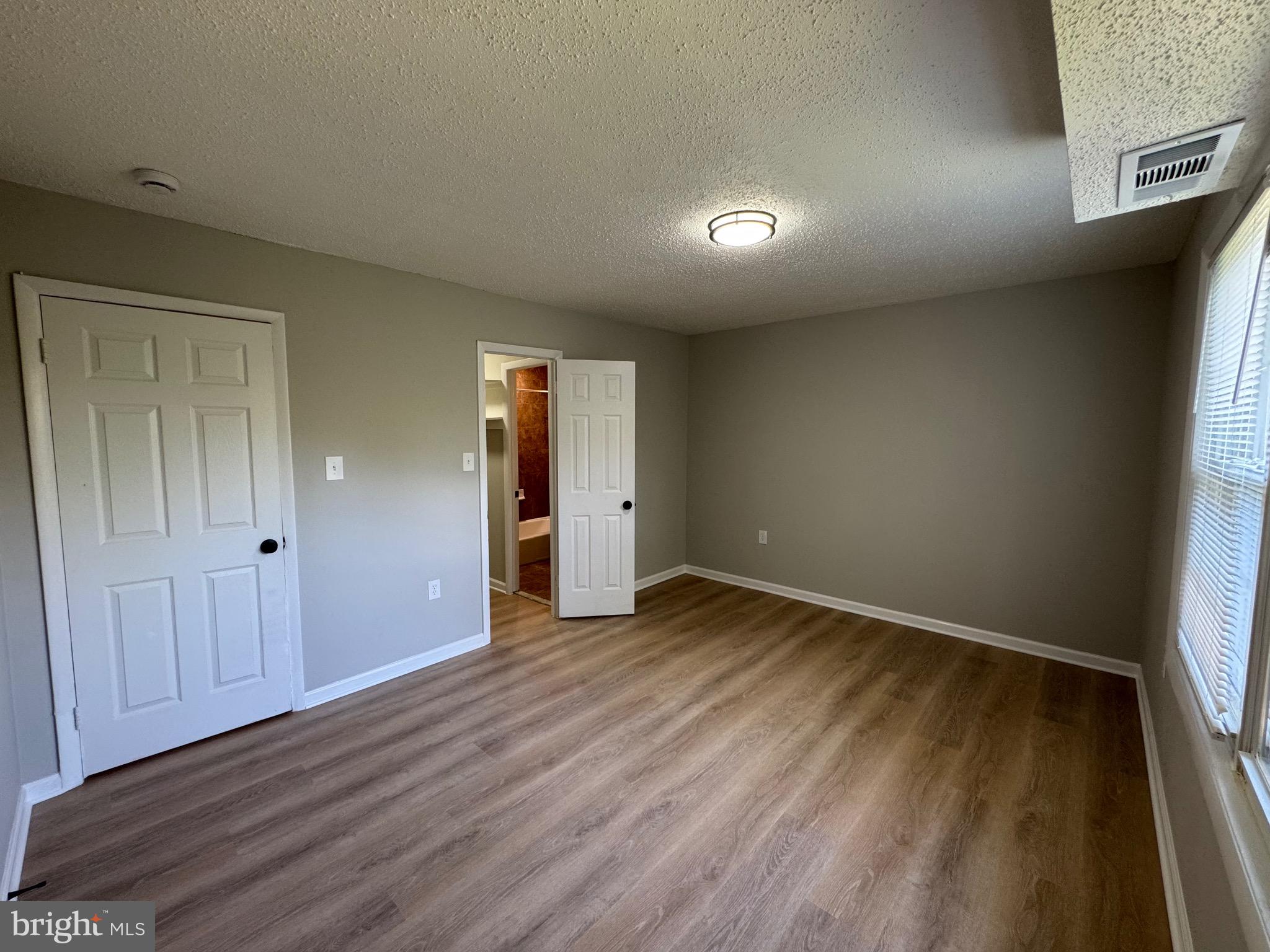 3817 Swann Road, Unit 302 Suitland, MD 20746 - Photo 20 of 26 an empty room with wooden floor and closet