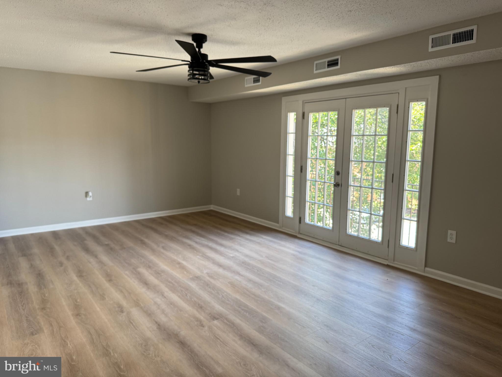 3817 Swann Road, Unit 302 Suitland, MD 20746 - Photo 2 of 26 a view of empty room with wooden floor and fan