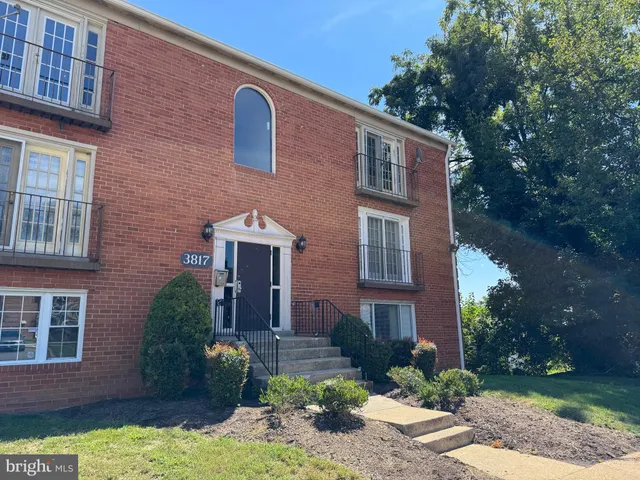 a front view of a house with yard and green space
