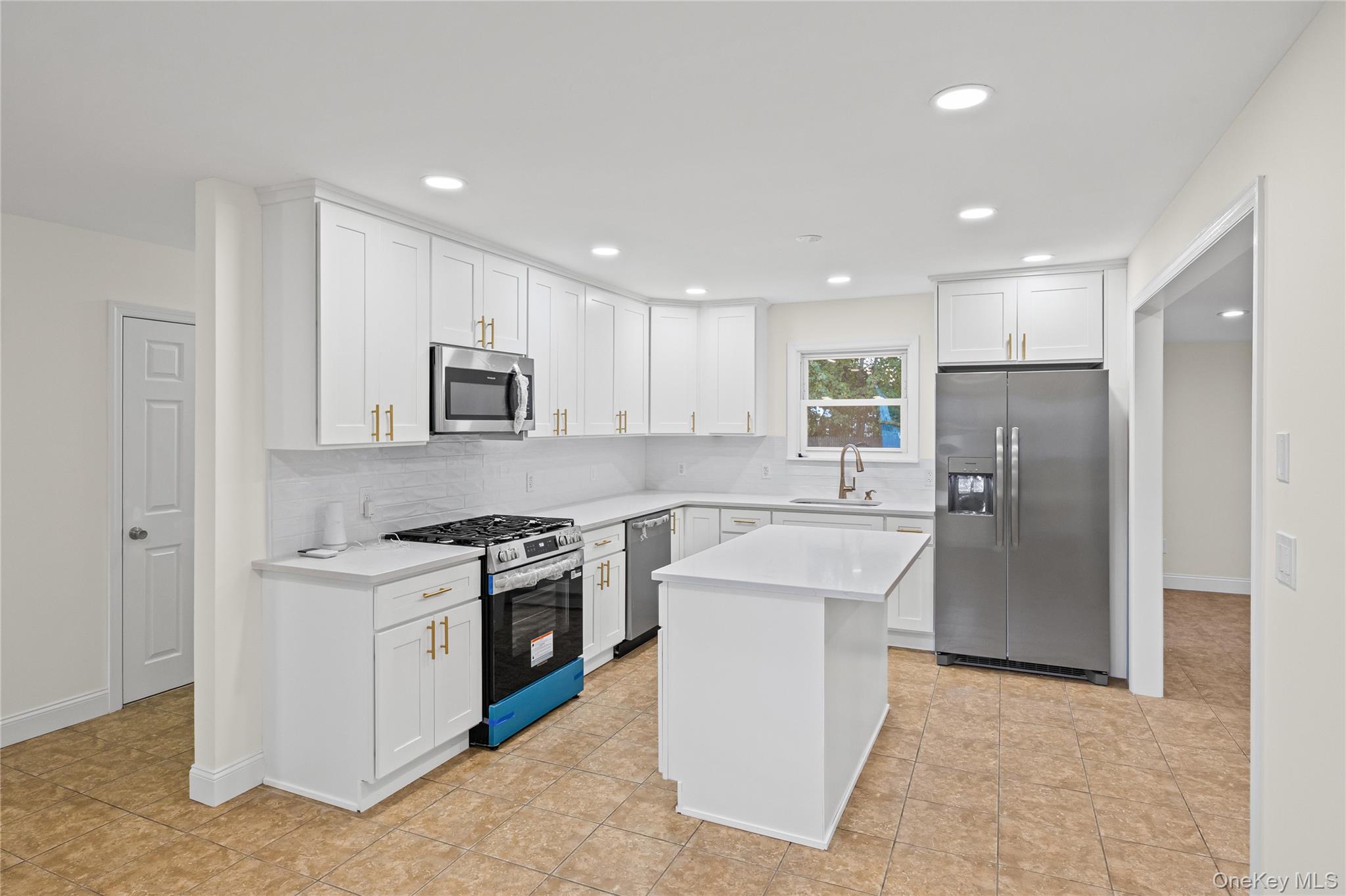 31 Colony Road Port Jefferson Station, NY 11776 - Photo 11 of 32 a kitchen with a stove a refrigerator and a sink