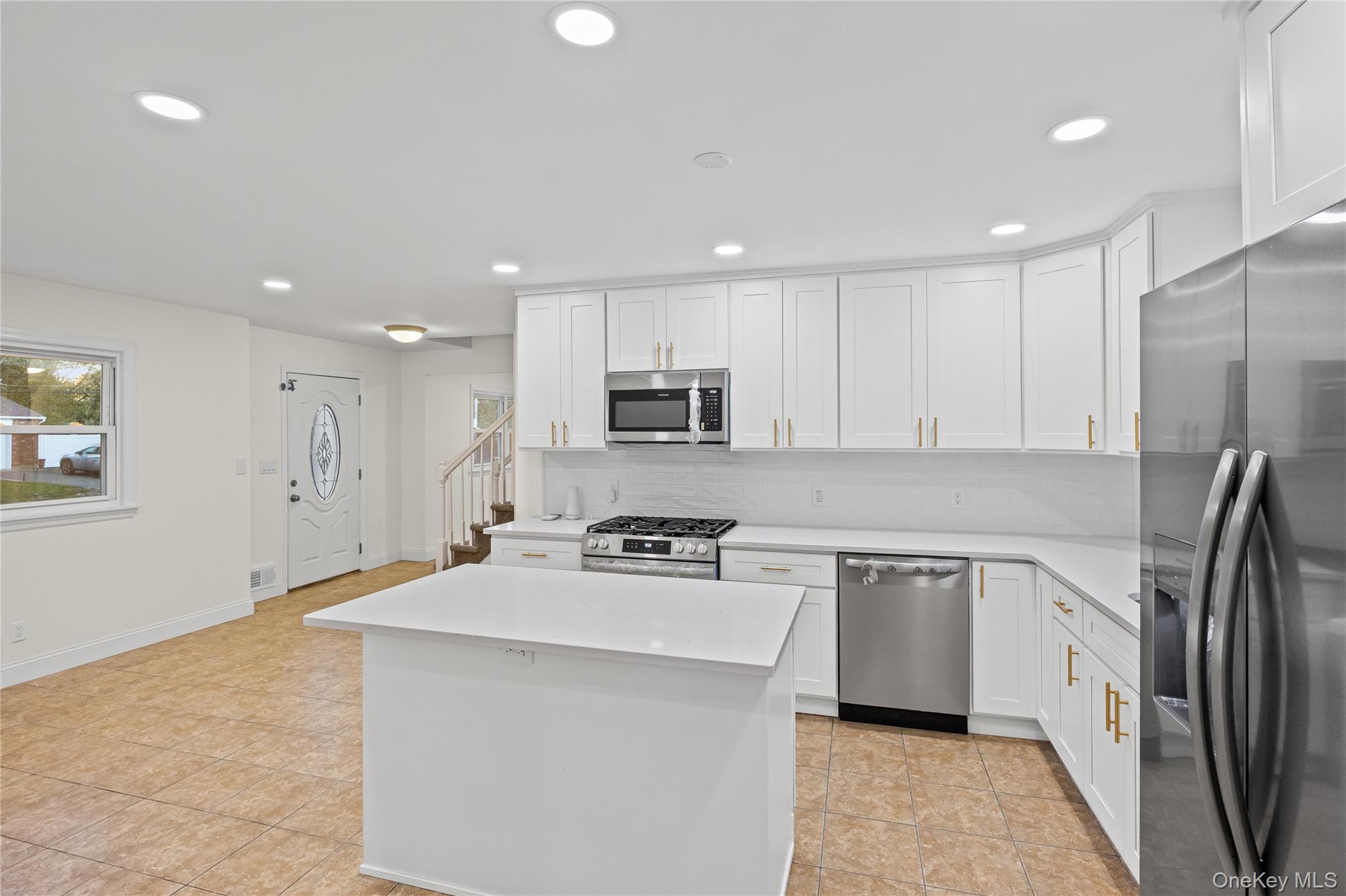 31 Colony Road Port Jefferson Station, NY 11776 - Photo 12 of 32 a kitchen with stainless steel appliances granite countertop a refrigerator sink and microwave