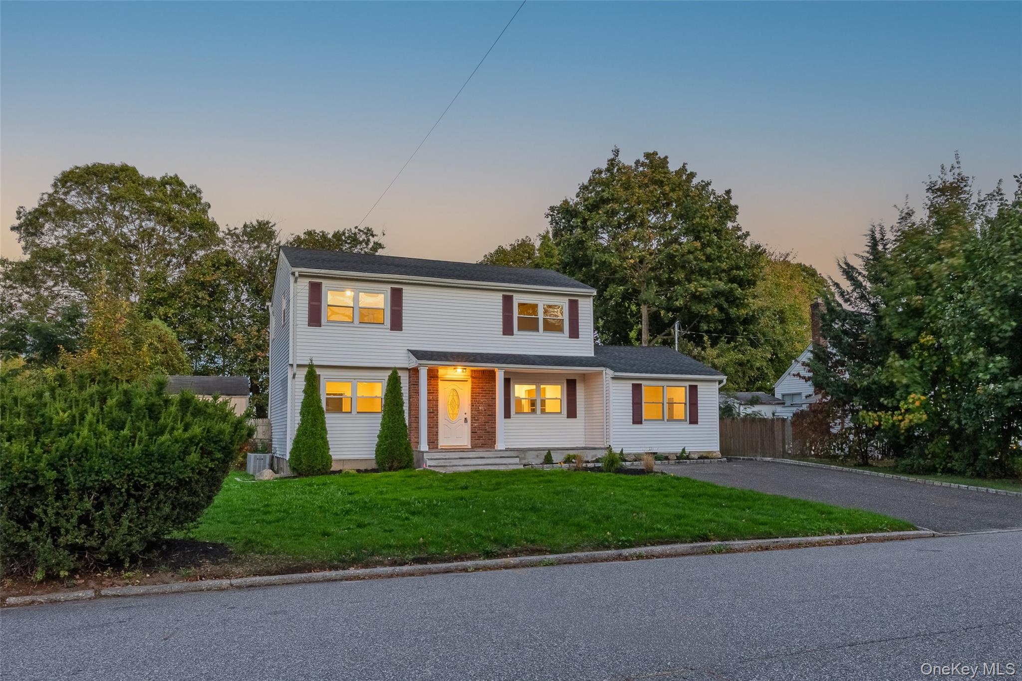31 Colony Road Port Jefferson Station, NY 11776 - Photo 2 of 32 a front view of a house with a yard and garage