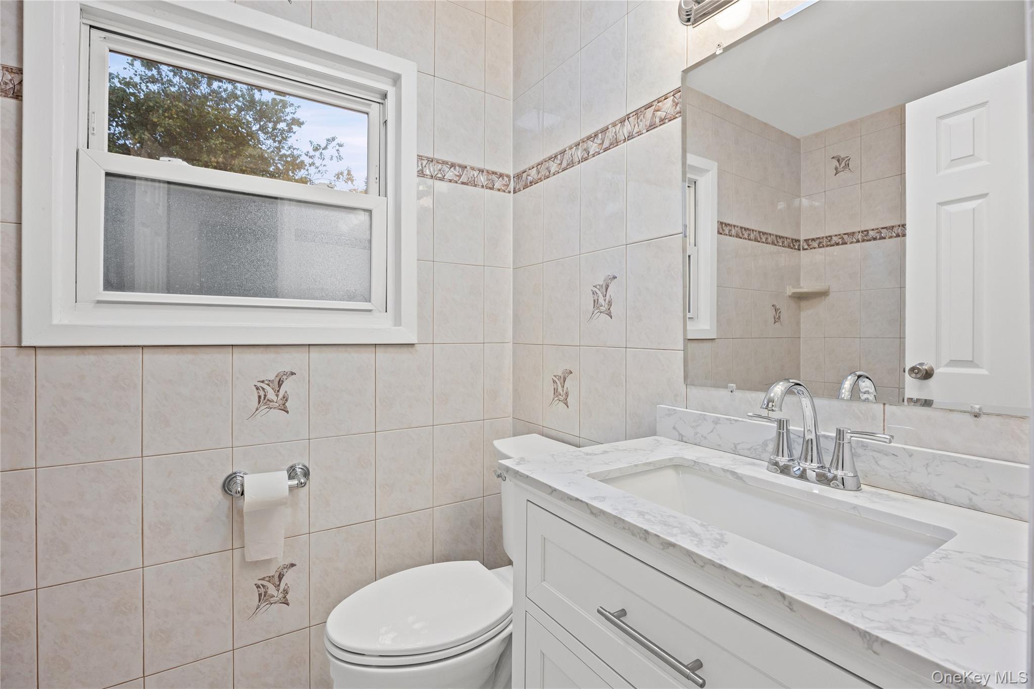 31 Colony Road Port Jefferson Station, NY 11776 - Photo 22 of 32 a bathroom with a granite countertop toilet sink and mirror
