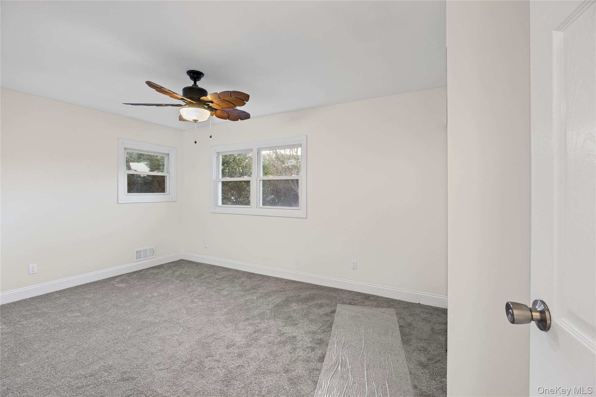 31 Colony Road Port Jefferson Station, NY 11776 - Photo 26 of 32 an empty room with windows and ceiling fan