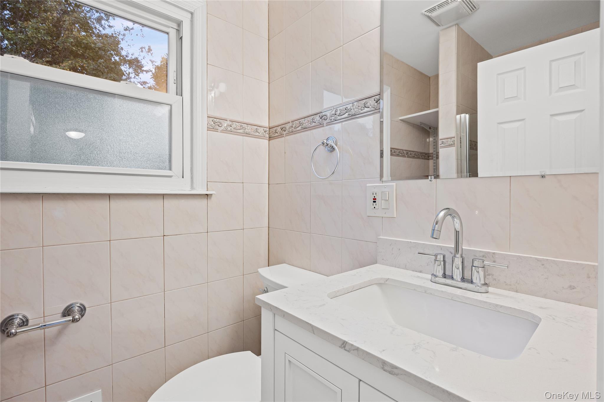 31 Colony Road Port Jefferson Station, NY 11776 - Photo 7 of 32 a bathroom with a sink toilet and vanity