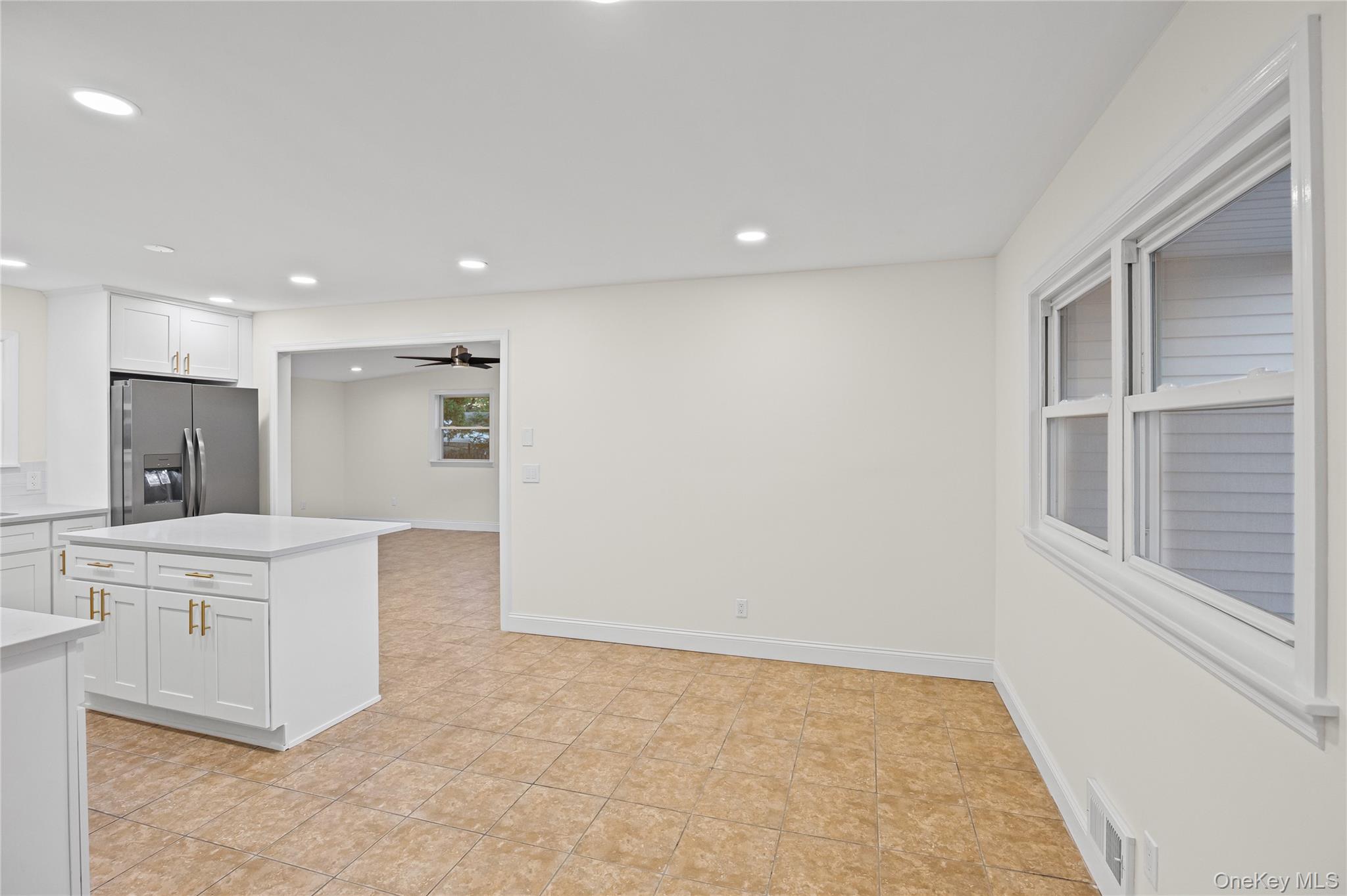 31 Colony Road Port Jefferson Station, NY 11776 - Photo 10 of 32 a large white kitchen with white cabinets and a refrigerator