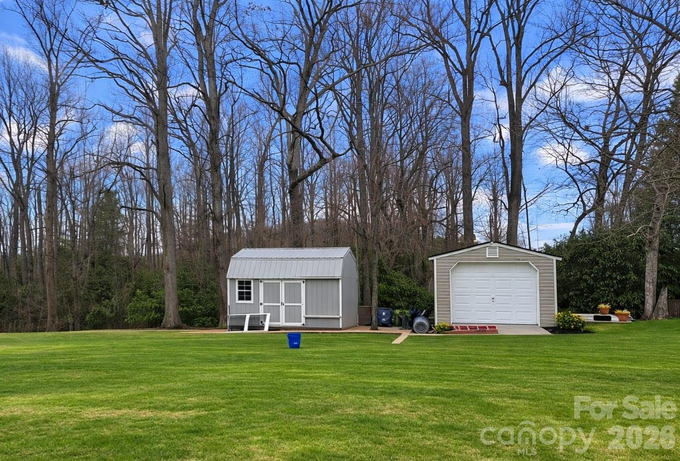 215 Lane Road Flat Rock, NC 28731 - Photo 3 of 3 a front view of a house with a garden and trees